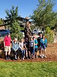 last group picture with statue of Rocky Mountain Park founder.