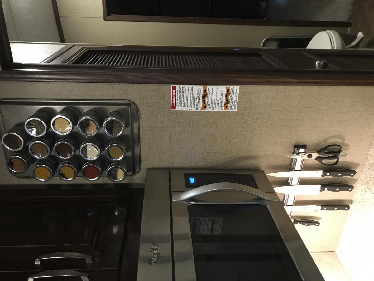 Jackie found this idea on Pinterest.  Cookie sheet and magnetic canisters for spices...